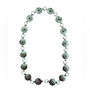 Southwest style Concho belt in silver with an orange trim.